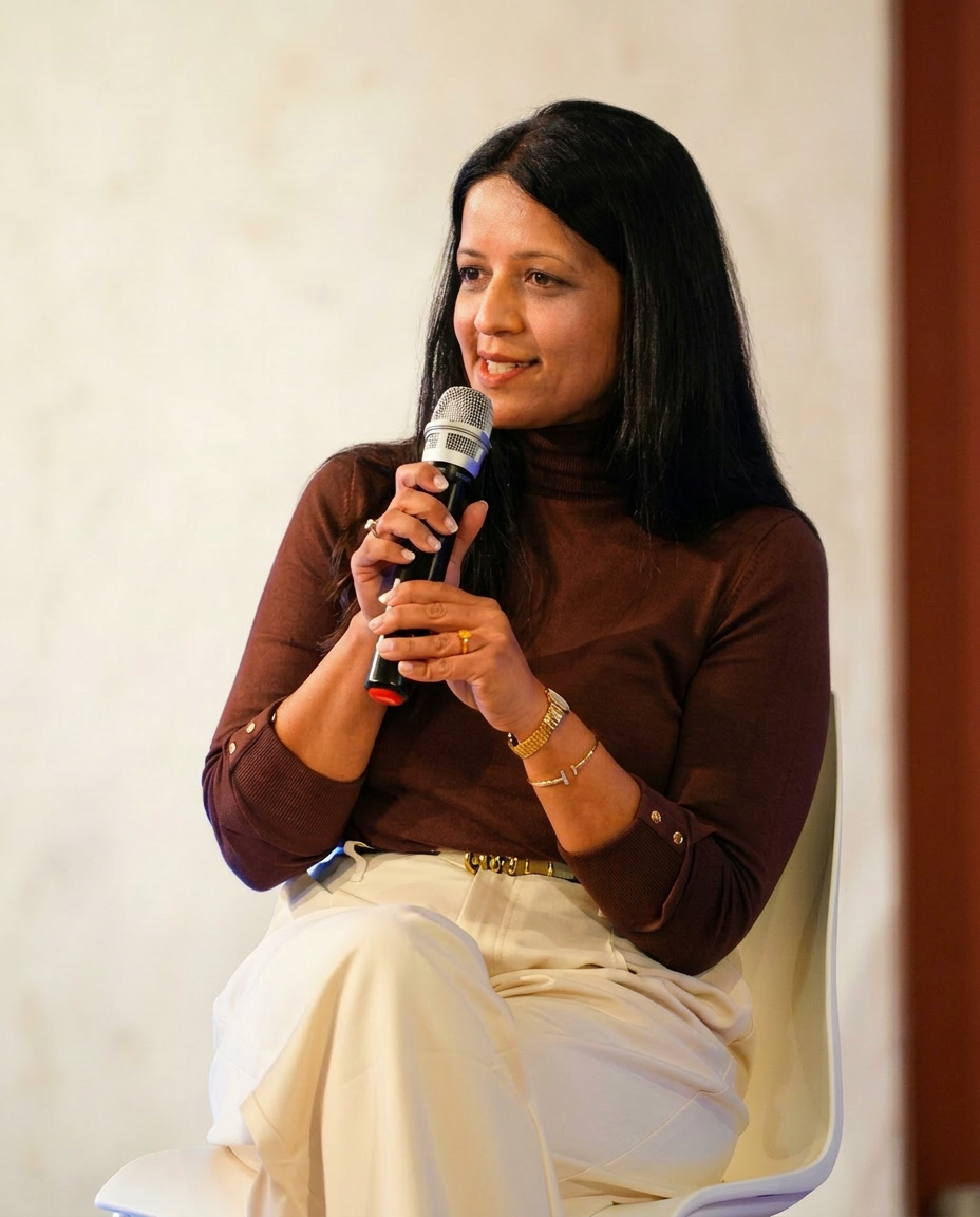 Shilpa on stage holding a microphone mid-conversation